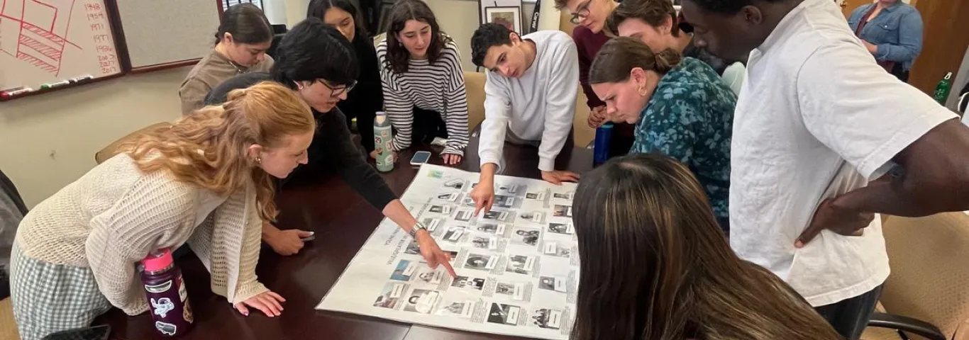 gcp students around a table working on a activity while in the 4TheVille office