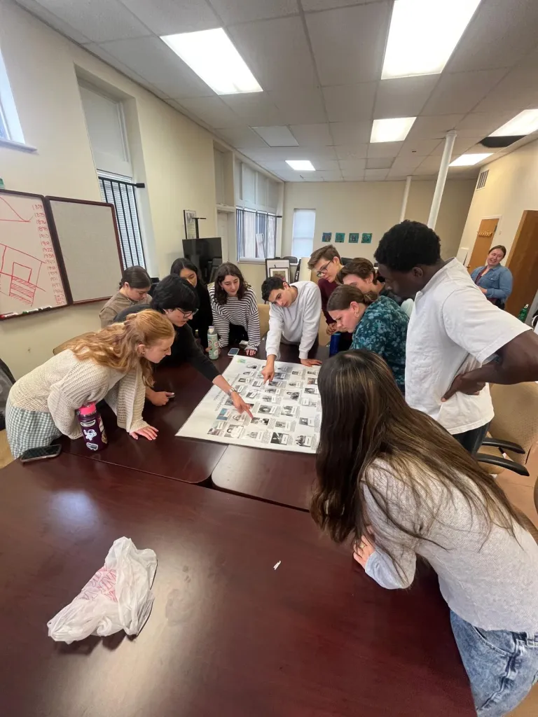 gcp students around a table working on a activity while in the 4TheVille office